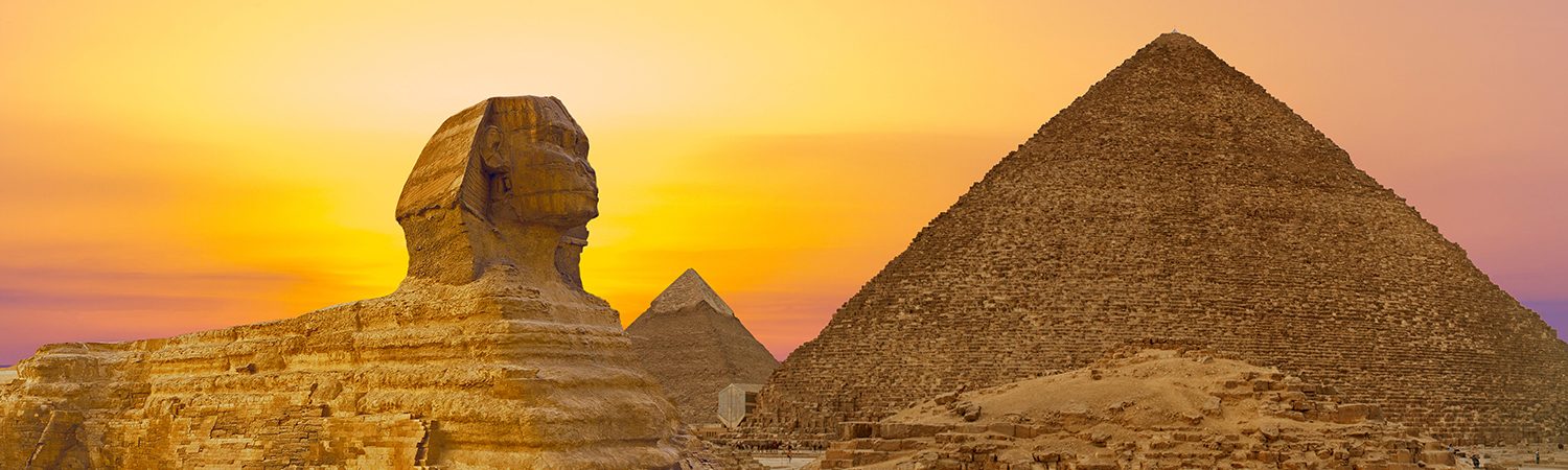 The Sphinx and Egyptian Pyramids during sunrise.